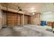 Spacious two-car garage with unfinished walls and a large door, shelving and storage at 7761 S Curtice Dr # C, Littleton, CO 80120