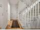 Entry hallway with staircase and hardwood floors, creating a welcoming and stylish entrance to the home at 7761 S Curtice Dr # C, Littleton, CO 80120