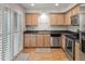 Bright kitchen featuring stainless steel appliances, granite countertops, hardwood floors, and ample cabinet space at 7761 S Curtice Dr # C, Littleton, CO 80120