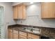 Double sink and granite countertops in the kitchen area, providing ample space for food preparation at 7761 S Curtice Dr # C, Littleton, CO 80120