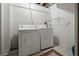 Bright laundry room featuring a side-by-side washer and dryer and shelving at 7761 S Curtice Dr # C, Littleton, CO 80120