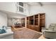 Open-concept layout with a living room, dining area, and staircase, all featuring hardwood floors at 7761 S Curtice Dr # C, Littleton, CO 80120
