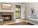 Inviting living room with a fireplace, tile floors, and natural light streaming through the front door at 7761 S Curtice Dr # C, Littleton, CO 80120