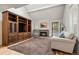 Spacious living room with a large entertainment center, vaulted ceiling, fireplace, and hardwood floors at 7761 S Curtice Dr # C, Littleton, CO 80120