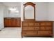 A dressing table stands in the main bedroom with a wooden dresser and ensuite bathroom at 7761 S Curtice Dr # C, Littleton, CO 80120