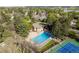 Aerial view of the large community pool and deck area surrounded by mature trees at 7761 S Curtice Dr # C, Littleton, CO 80120