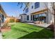 Beautiful backyard with a well-manicured lawn, stone patio, and stylish outdoor furniture at 2365 S Clayton St, Denver, CO 80210