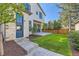 Exterior view showcasing a patio, stone accents, and a well-maintained yard at 2365 S Clayton St, Denver, CO 80210