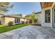 Backyard with stone patio, a stone outbuilding, and green lawn at 2365 S Clayton St, Denver, CO 80210