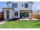 Inviting backyard with a stone patio, comfortable outdoor seating, and modern architectural details at 2365 S Clayton St, Denver, CO 80210