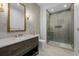 Well-lit bathroom featuring a glass shower, a single vanity and neutral tiling at 2365 S Clayton St, Denver, CO 80210