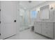 Elegant bathroom with glass enclosed shower, white vanity, modern fixtures and tile flooring at 2365 S Clayton St, Denver, CO 80210