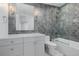 Stylish bathroom features grey tile, glass enclosed shower, white vanity and modern fixtures at 2365 S Clayton St, Denver, CO 80210