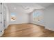 Bright bedroom with wood floors, two windows and crisp white trim at 2365 S Clayton St, Denver, CO 80210