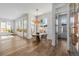 Bright dining area features hardwood floors, large windows, and stylish pendant lighting at 2365 S Clayton St, Denver, CO 80210