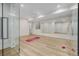Bright exercise room with mirrored walls, wood floors, and a ceiling fan at 2365 S Clayton St, Denver, CO 80210