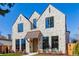 Elegant stone home with a copper awning over the arched front door at 2365 S Clayton St, Denver, CO 80210