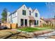 Charming stone home with manicured lawn and striking window trim at 2365 S Clayton St, Denver, CO 80210