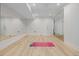 Bright home gym featuring mirrored wall, light wood flooring, and glass enclosed room at 2365 S Clayton St, Denver, CO 80210