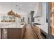 Well-lit modern kitchen with large island, designer light fixtures and custom cabinets at 2365 S Clayton St, Denver, CO 80210
