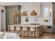 Bright kitchen features large island with seating and designer woven pendant lighting at 2365 S Clayton St, Denver, CO 80210