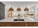 Open kitchen boasts a spacious island, designer lighting, and seamless flow to the living area at 2365 S Clayton St, Denver, CO 80210