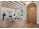 Bright living room with wood beams, fireplace and arched front door at 2365 S Clayton St, Denver, CO 80210