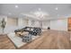 Spacious living room with hardwood floors, modern lighting, and a stylish sofa at 2365 S Clayton St, Denver, CO 80210