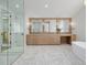 Luxurious main bathroom with double vanity, marble floors, glass enclosed shower, and soaking tub at 2365 S Clayton St, Denver, CO 80210