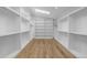 Bright walk-in closet featuring custom shelving, a skylight and wood floors at 2365 S Clayton St, Denver, CO 80210