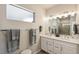 Modern bathroom with double sinks, vanity with drawers, and tiled walk-in shower at 763 Sage Forest Ln, Monument, CO 80132