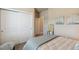 Bright bedroom features a comfortable bed, unique decor, and closet with sliding doors for ample storage at 763 Sage Forest Ln, Monument, CO 80132