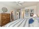 Comfortable bedroom featuring a striped bedspread and access to a walk-in closet and bathroom at 763 Sage Forest Ln, Monument, CO 80132