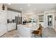 Modern kitchen with white cabinets, stainless steel appliances, and an island with seating at 763 Sage Forest Ln, Monument, CO 80132