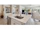 Gorgeous kitchen island and bar, with stainless steel dishwasher and adjacent living spaces at 763 Sage Forest Ln, Monument, CO 80132