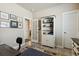 Inviting office space features a blue rug, white bookcase, and multiple framed pictures at 763 Sage Forest Ln, Monument, CO 80132