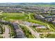 An aerial view captures a neighborhood with well-planned streets, houses, and green spaces, showcasing a suburban community at 10057 Des Moines St, Parker, CO 80134