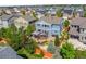 Aerial view of a home with backyard pergola, landscaping, and a community surrounded by lush greenery at 10057 Des Moines St, Parker, CO 80134