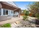 Backyard patio with a dark wood pergola, outdoor seating, and beautiful landscaping, creating a relaxing retreat at 10057 Des Moines St, Parker, CO 80134