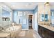 Modern bathroom with a soaking tub, walk-in shower, double vanity and walk-in closet at 10057 Des Moines St, Parker, CO 80134