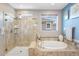 Bright bathroom featuring a walk-in shower, soaking tub, and tile accents at 10057 Des Moines St, Parker, CO 80134