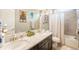 Bright bathroom with double sinks, granite countertops, modern fixtures, and a shower-tub combination at 10057 Des Moines St, Parker, CO 80134