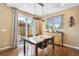 Bright dining area featuring a marble table, modern lighting, and sliding glass doors leading to a patio at 10057 Des Moines St, Parker, CO 80134
