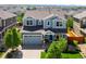 Charming two-story home with blue siding, well-manicured lawn, and an attached two-car garage in a suburban neighborhood at 10057 Des Moines St, Parker, CO 80134