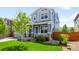 Charming two-story house with blue siding, a welcoming front porch, a well-manicured lawn and a neatly landscaped yard at 10057 Des Moines St, Parker, CO 80134