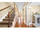 Spacious hallway with hardwood floors leading to various rooms and a staircase with wrought iron spindles at 10057 Des Moines St, Parker, CO 80134