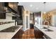 Sleek kitchen with an island, granite counters, stainless steel appliances, stylish backsplash, and hardwood floors at 10057 Des Moines St, Parker, CO 80134