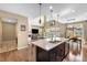 Spacious kitchen with a large island, pendant lighting, and open view to the living room and dining area at 10057 Des Moines St, Parker, CO 80134