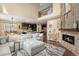 Inviting living room and kitchen featuring hardwood floors, a cozy fireplace, and an open floor plan perfect for gatherings at 10057 Des Moines St, Parker, CO 80134