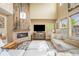 Cozy living room features a stone fireplace, high ceilings, and comfortable seating with large windows at 10057 Des Moines St, Parker, CO 80134